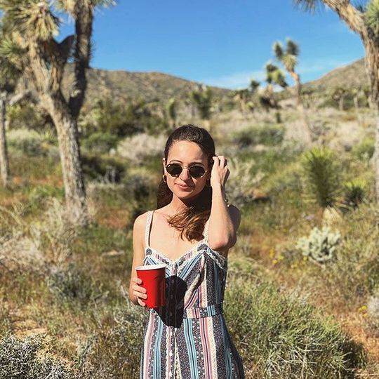 Woman standing in desert holding SOLO red cup